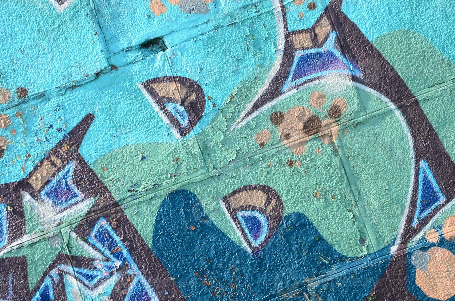 Fragment of graffiti drawings. The old wall decorated with paint stains in the style of street art culture. Colored background texture in cold tones photo