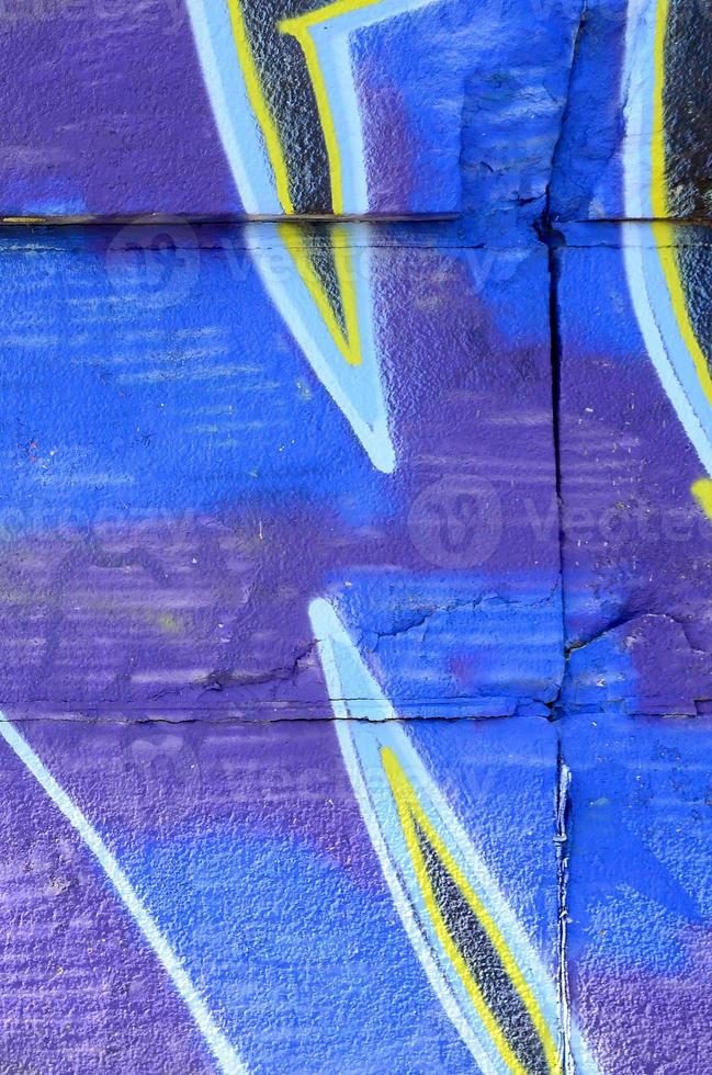 Fragment of graffiti drawings. The old wall decorated with paint stains in the style of street art culture. Colored background texture in cold tones photo