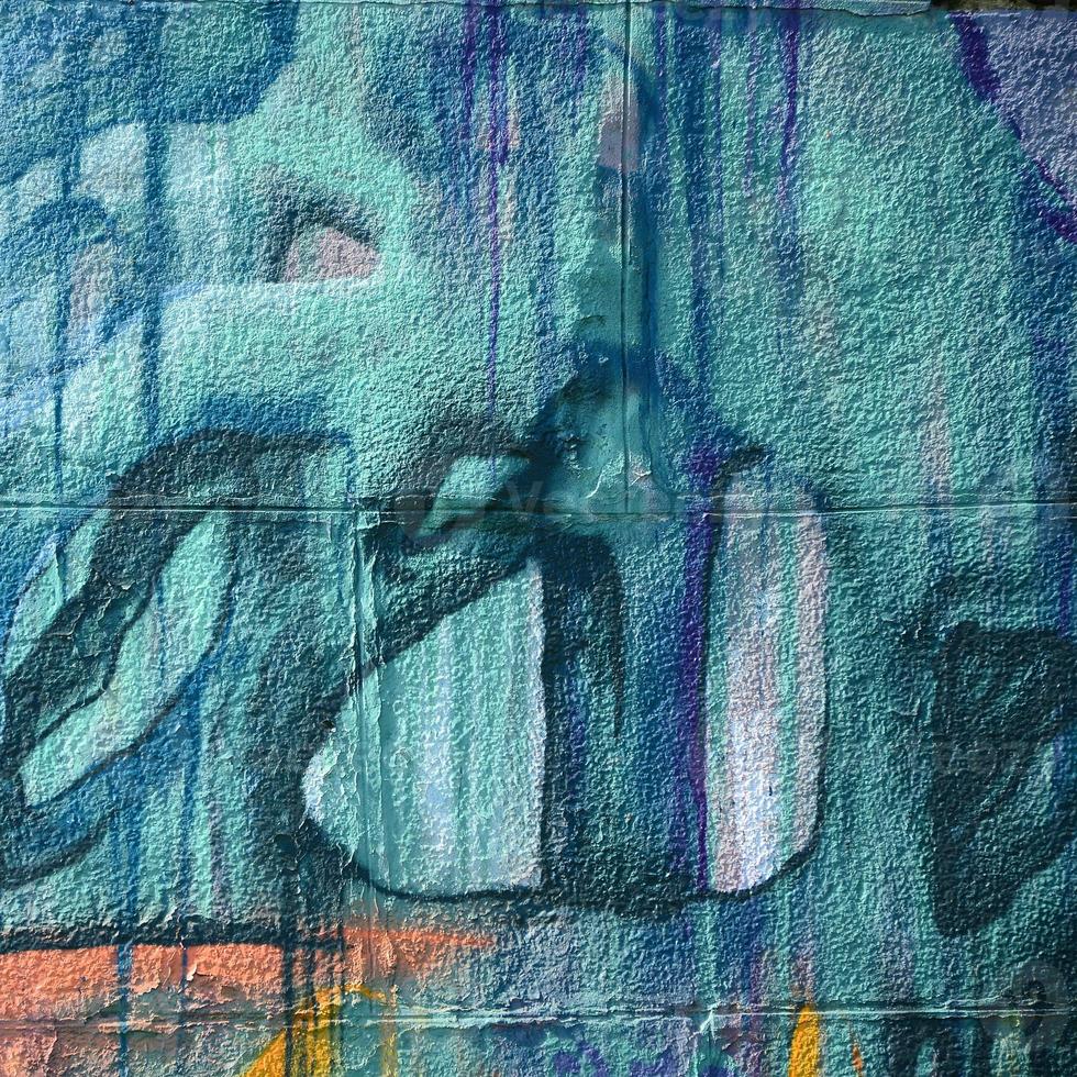 Fragment of graffiti drawings. The old wall decorated with paint stains in the style of street art culture. Multicolored background texture photo