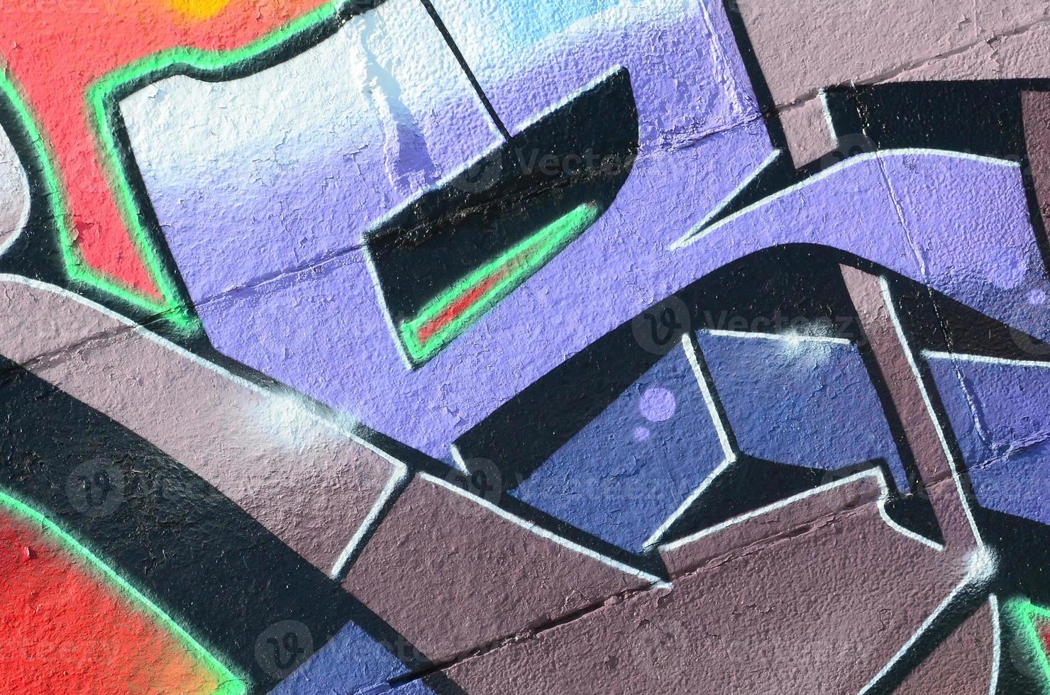 Fragment of graffiti drawings. The old wall decorated with paint stains in the style of street art culture. Colored background texture in purple tones photo