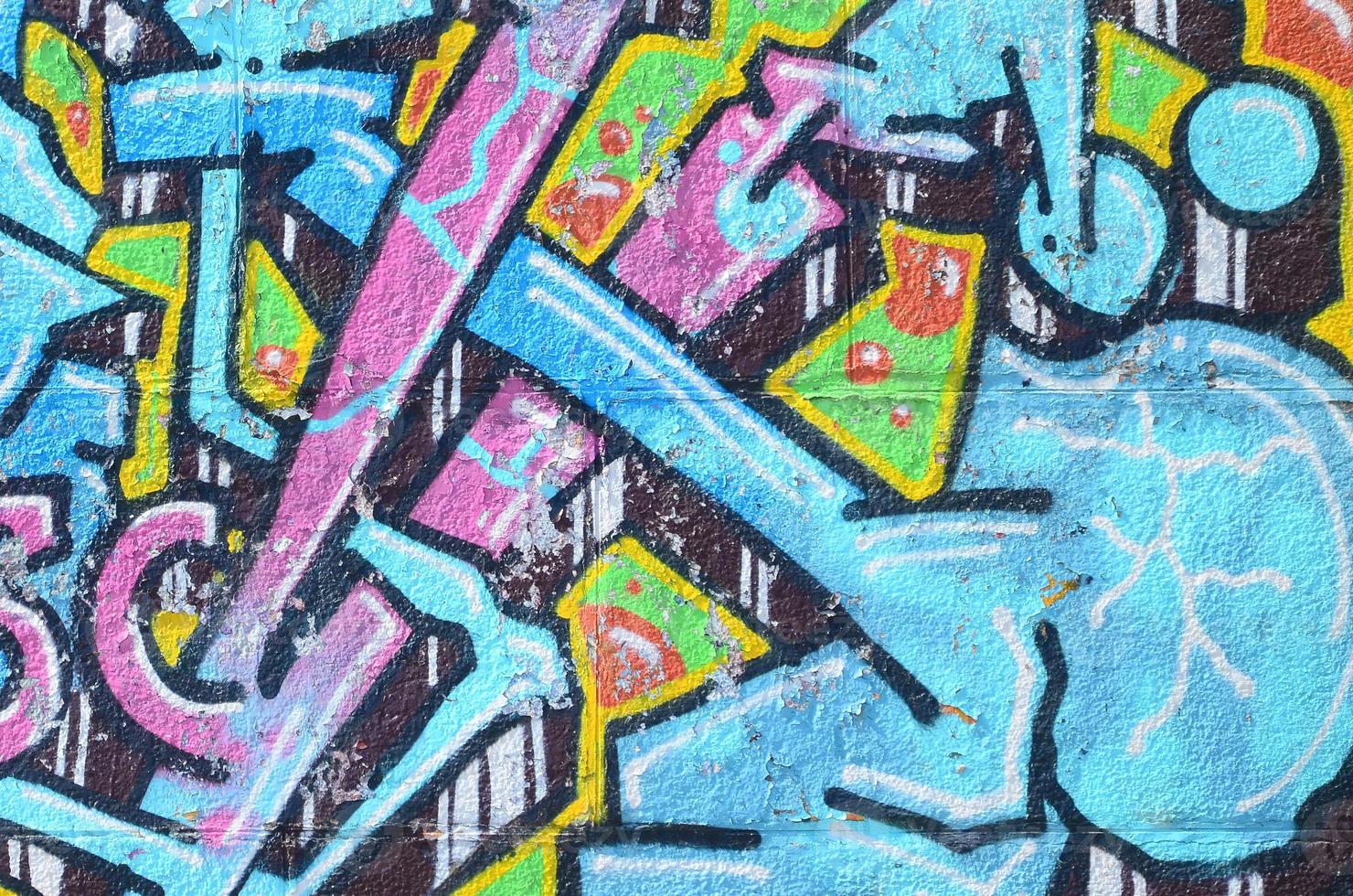 fragmento de dibujos de graffiti. la antigua muralla decorada con manchas de pintura al estilo de la cultura del arte callejero. textura de fondo coloreada en tonos fríos foto