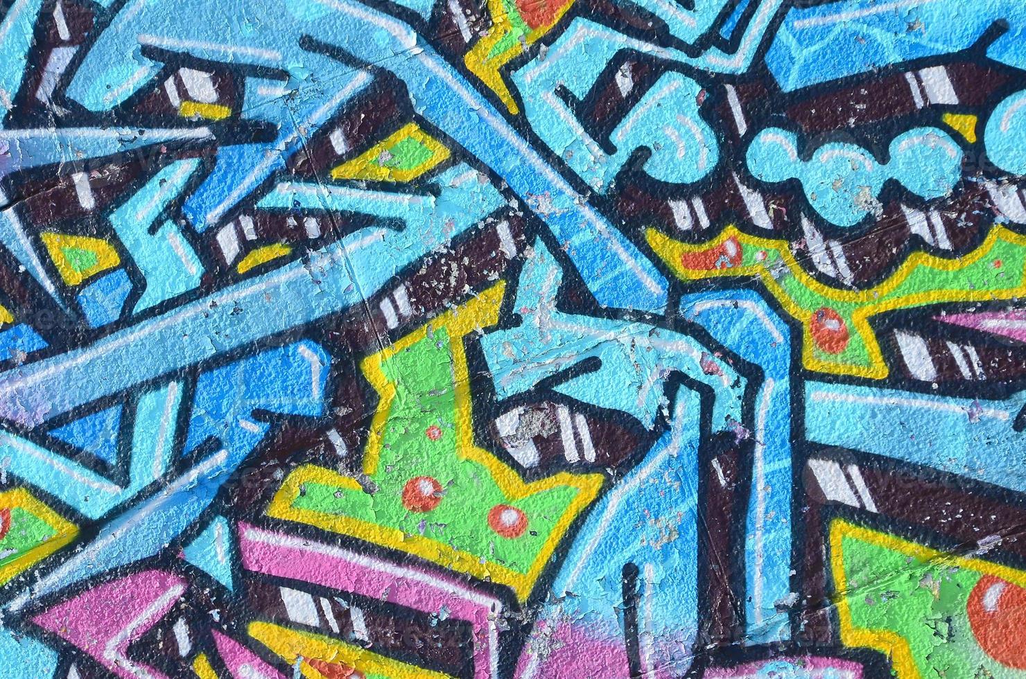 Fragment of graffiti drawings. The old wall decorated with paint stains in the style of street art culture. Colored background texture in cold tones photo
