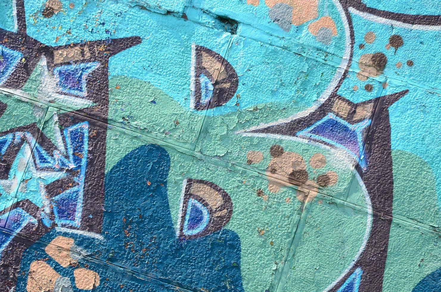 Fragment of graffiti drawings. The old wall decorated with paint stains in the style of street art culture. Colored background texture in cold tones photo