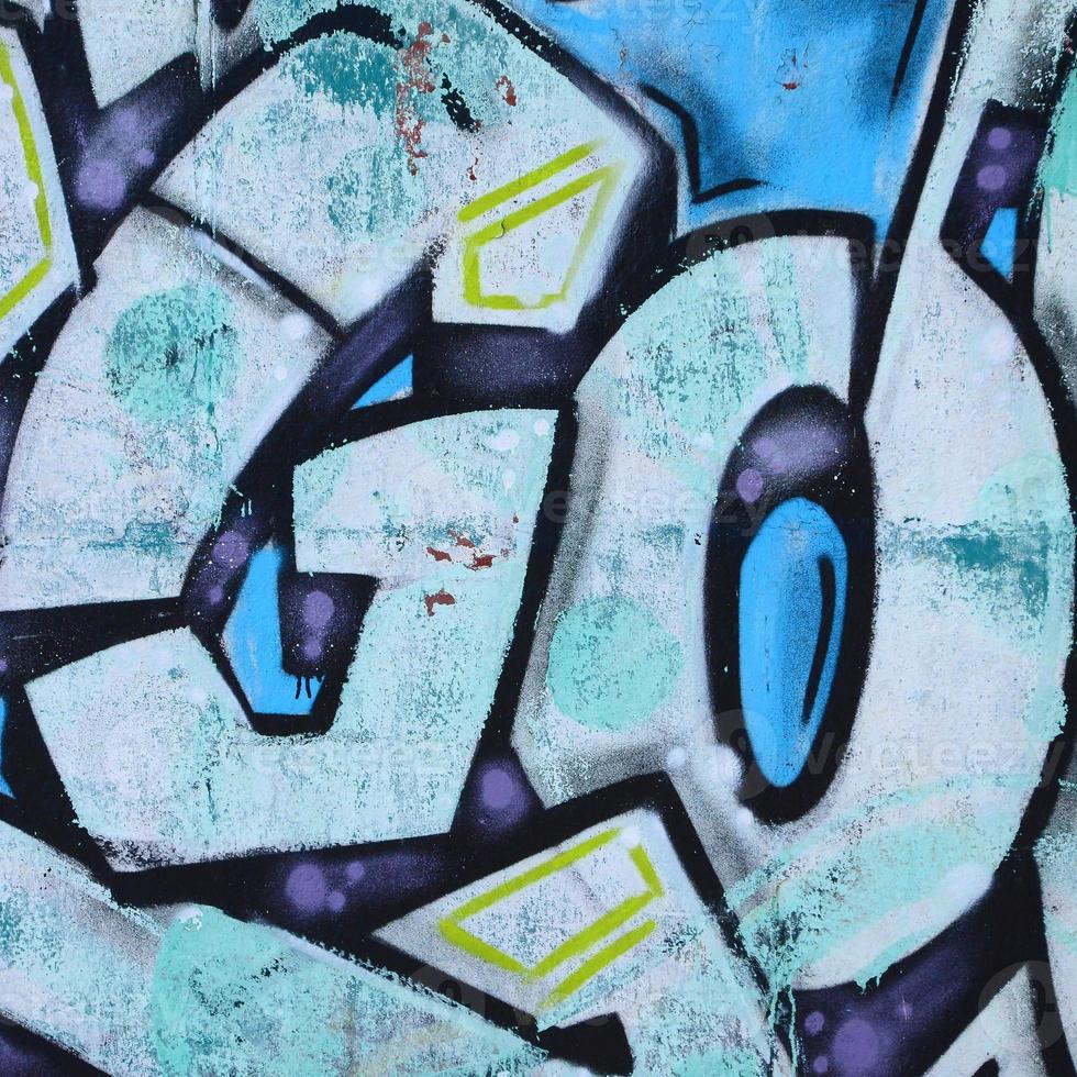 Fragment of graffiti drawings. The old wall decorated with paint stains in the style of street art culture. Colored background texture in cold tones photo