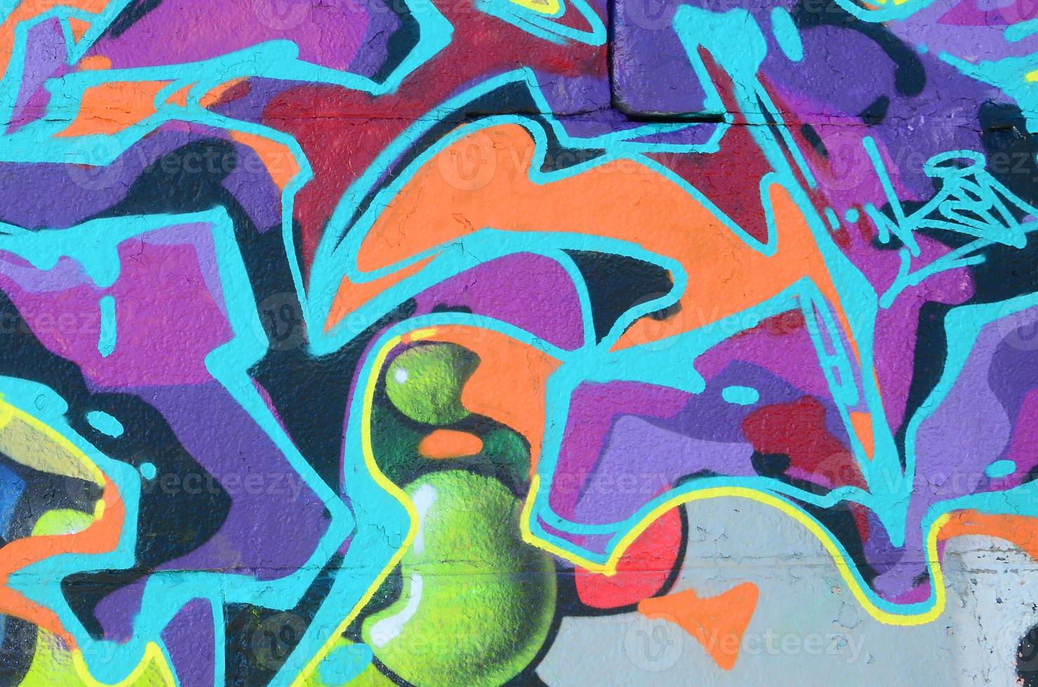 Fragment of graffiti drawings. The old wall decorated with paint stains in the style of street art culture. Multicolored background texture photo