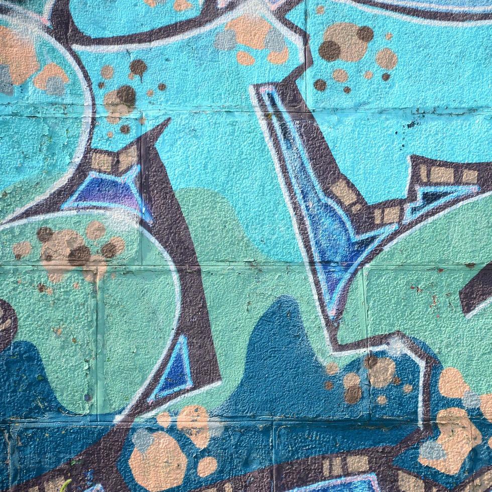 Fragment of graffiti drawings. The old wall decorated with paint stains in the style of street art culture. Colored background texture in cold tones photo