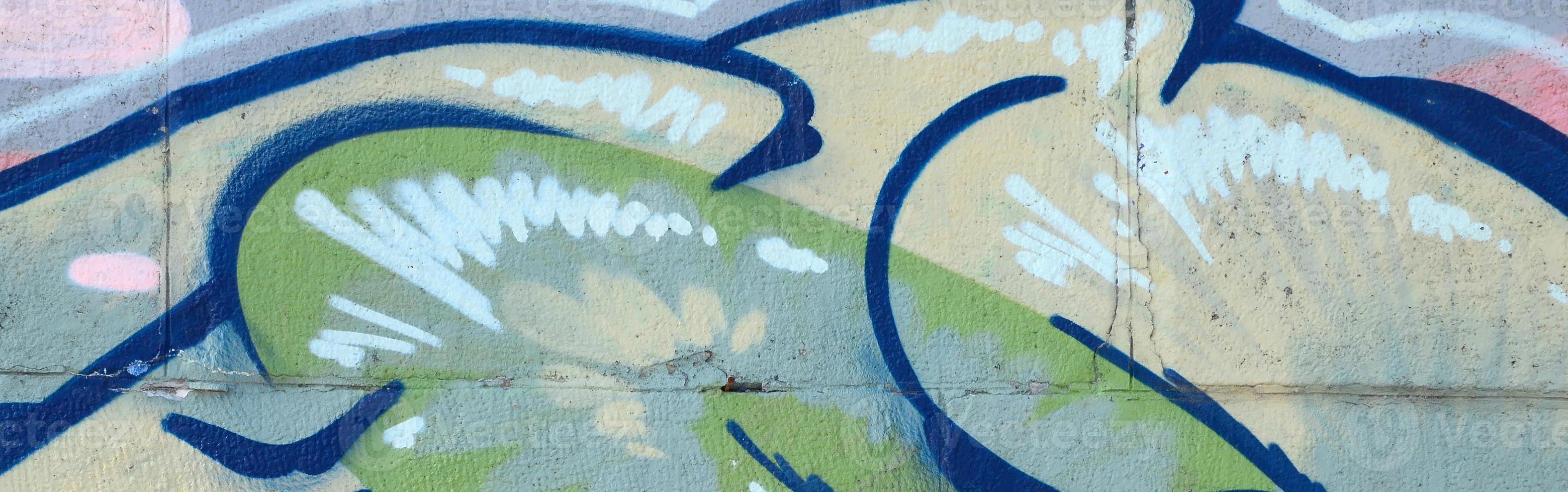 Fragment of graffiti drawings. The old wall decorated with paint stains in the style of street art culture. Colored background texture in green tones photo