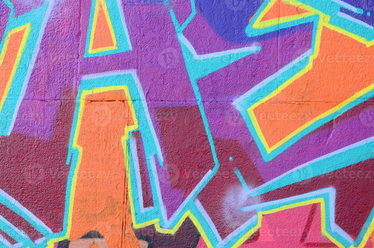 Fragment of graffiti drawings. The old wall decorated with paint stains in the style of street art culture. Colored background texture in purple tones photo