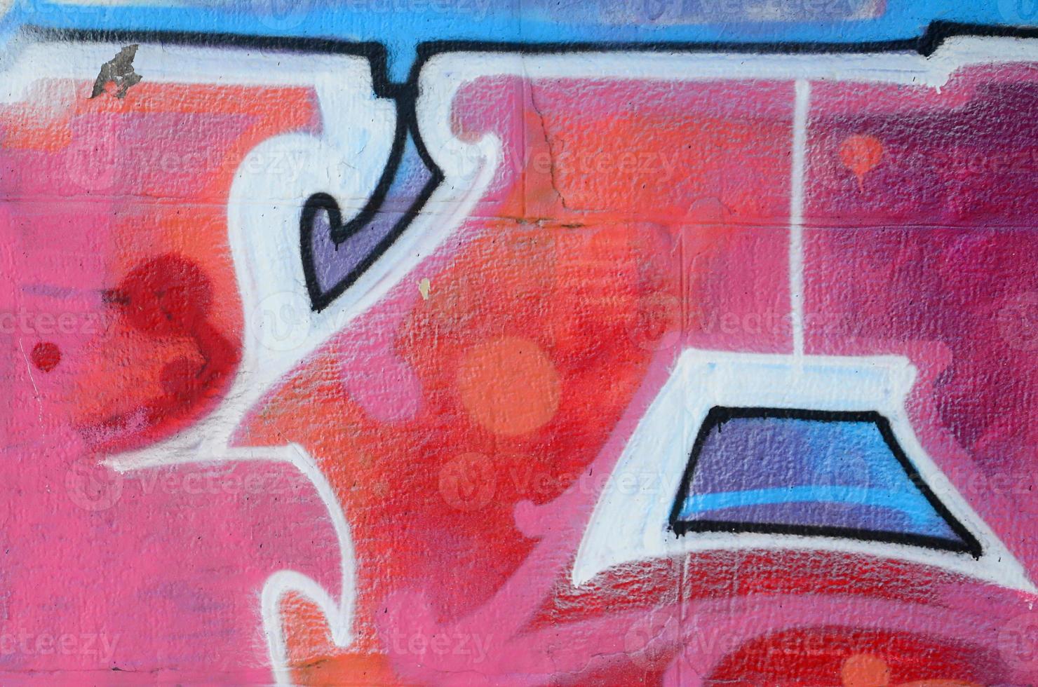 Fragment of graffiti drawings. The old wall decorated with paint stains in the style of street art culture. Colored background texture in warm tones photo