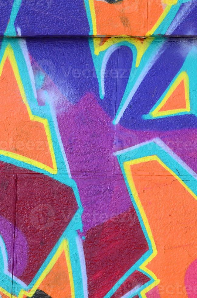 Fragment of graffiti drawings. The old wall decorated with paint stains in the style of street art culture. Colored background texture in purple tones photo
