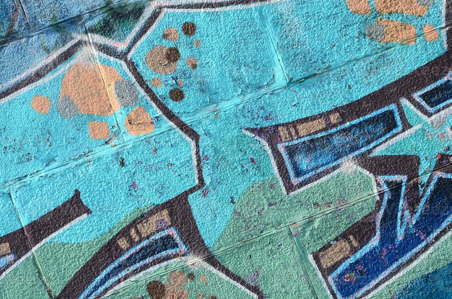 Fragment of graffiti drawings. The old wall decorated with paint stains in the style of street art culture. Colored background texture in cold tones photo