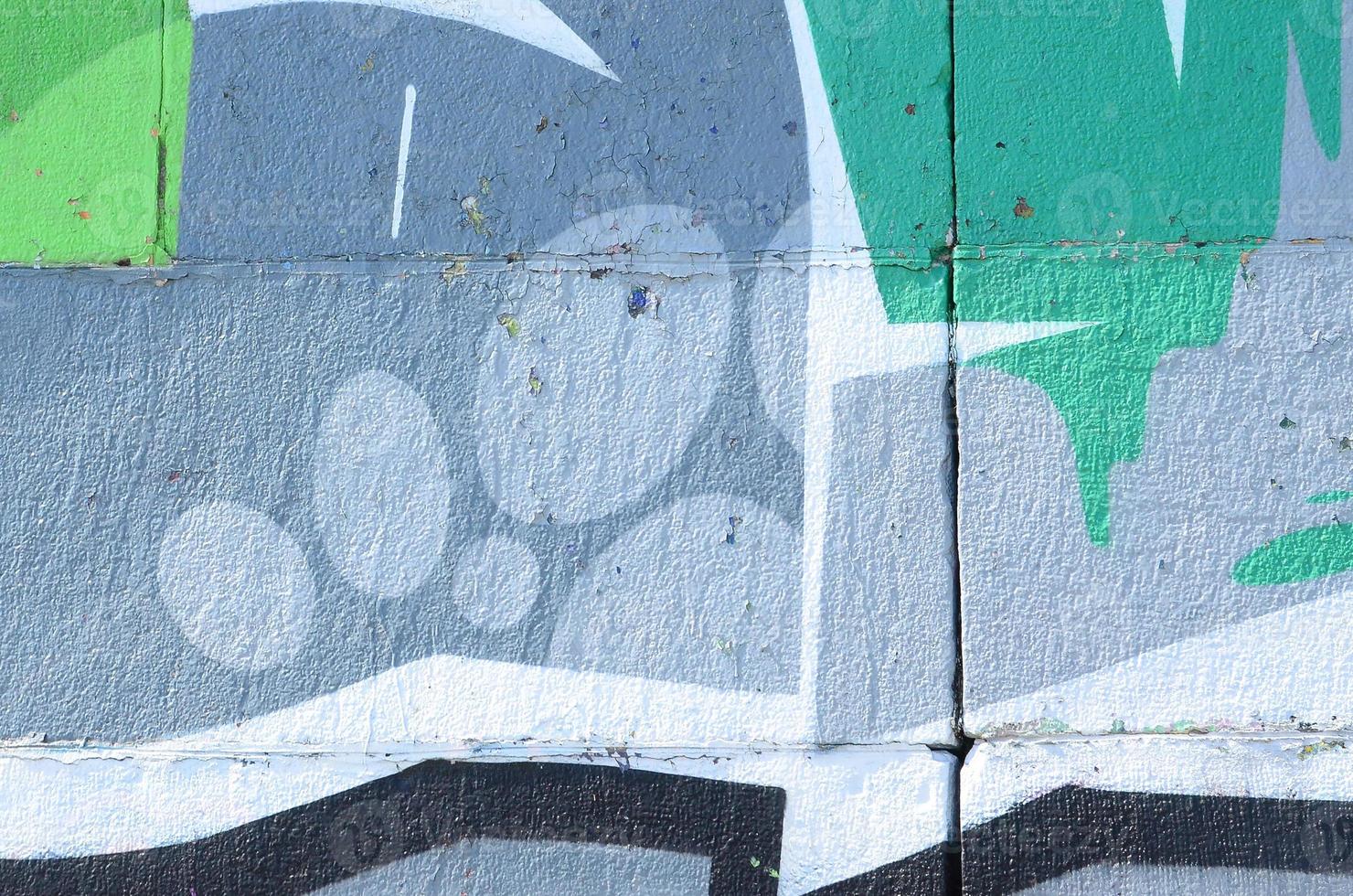 Fragment of graffiti drawings. The old wall decorated with paint stains in the style of street art culture. Colored background texture in green tones photo