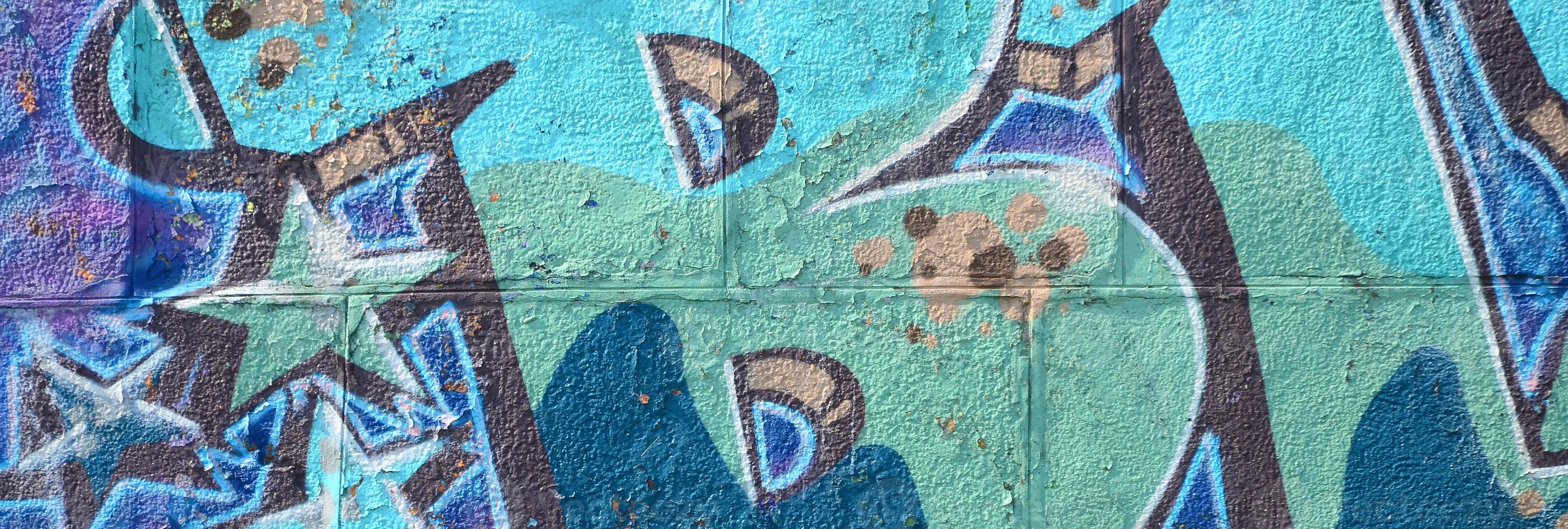 Fragment of graffiti drawings. The old wall decorated with paint stains in the style of street art culture. Colored background texture in cold tones photo