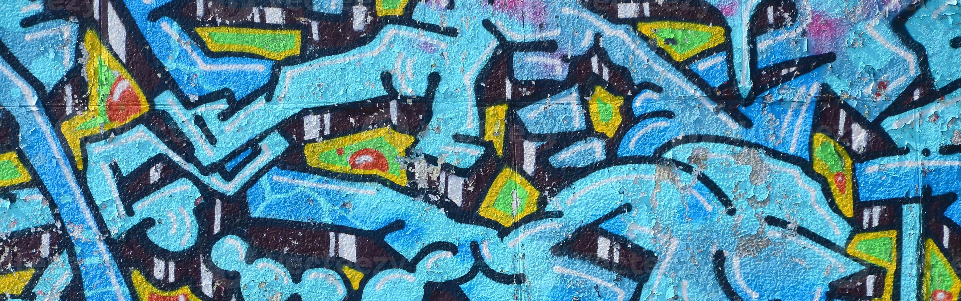 fragmento de dibujos de graffiti. la antigua muralla decorada con manchas de pintura al estilo de la cultura del arte callejero. textura de fondo coloreada en tonos fríos foto