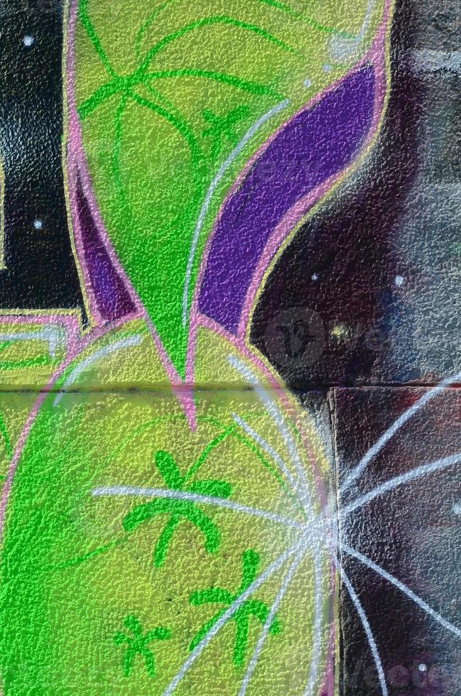 Fragment of graffiti drawings. The old wall decorated with paint stains in the style of street art culture. Colored background texture in green tones photo