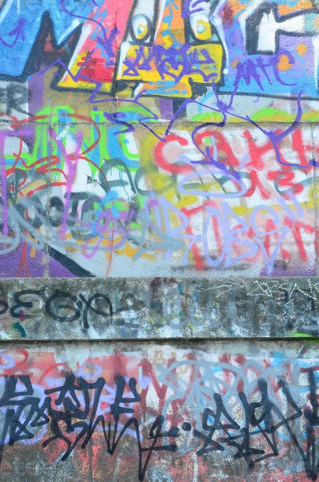 Fragment of graffiti tags. The old wall is spoiled with paint stains in the style of street art culture photo