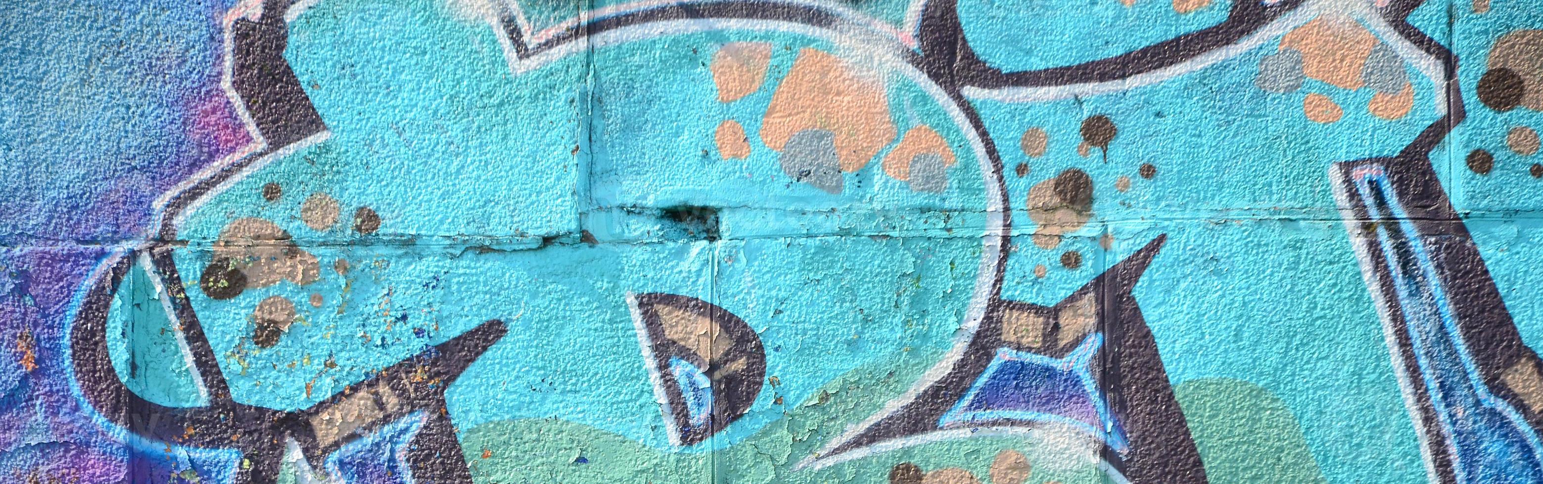 fragmento de dibujos de graffiti. la antigua muralla decorada con manchas de pintura al estilo de la cultura del arte callejero. textura de fondo coloreada en tonos fríos foto