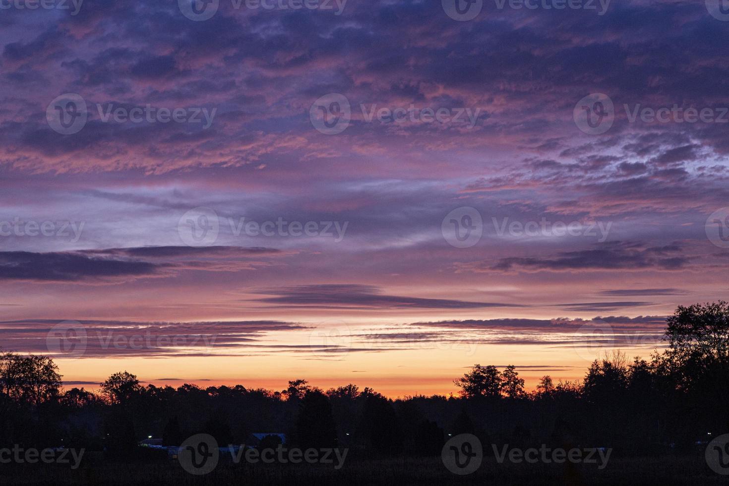 Image of a colorful and high-contrast sunrise with bright cloud formations taken in Germany photo