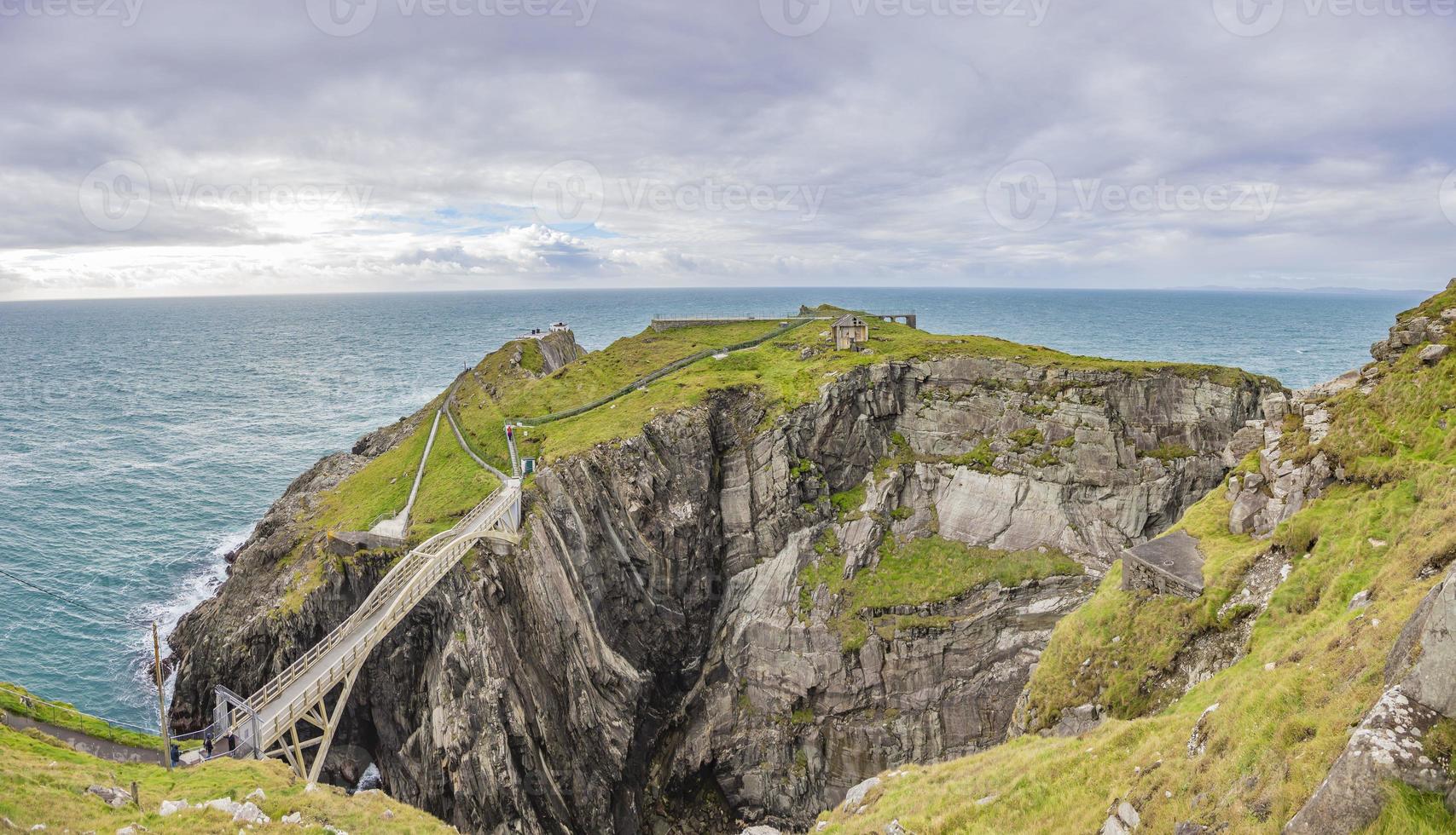 Pedastrian bridge to Mizen Head lighthouse in southern west Ireland during daytime photo