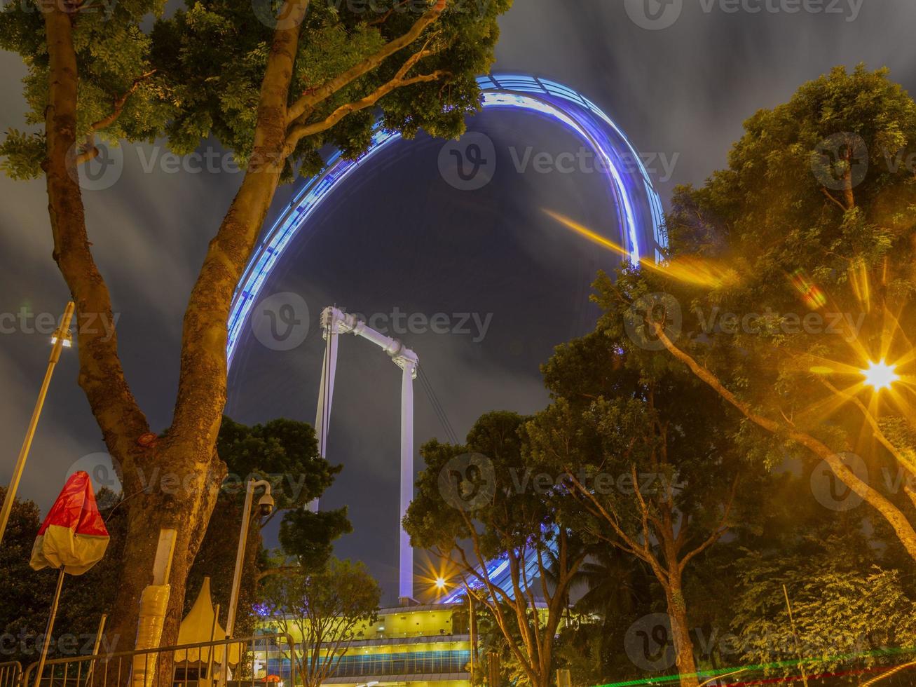 Night scene from Singapore Marina Bay district with Singapore flyer in September photo