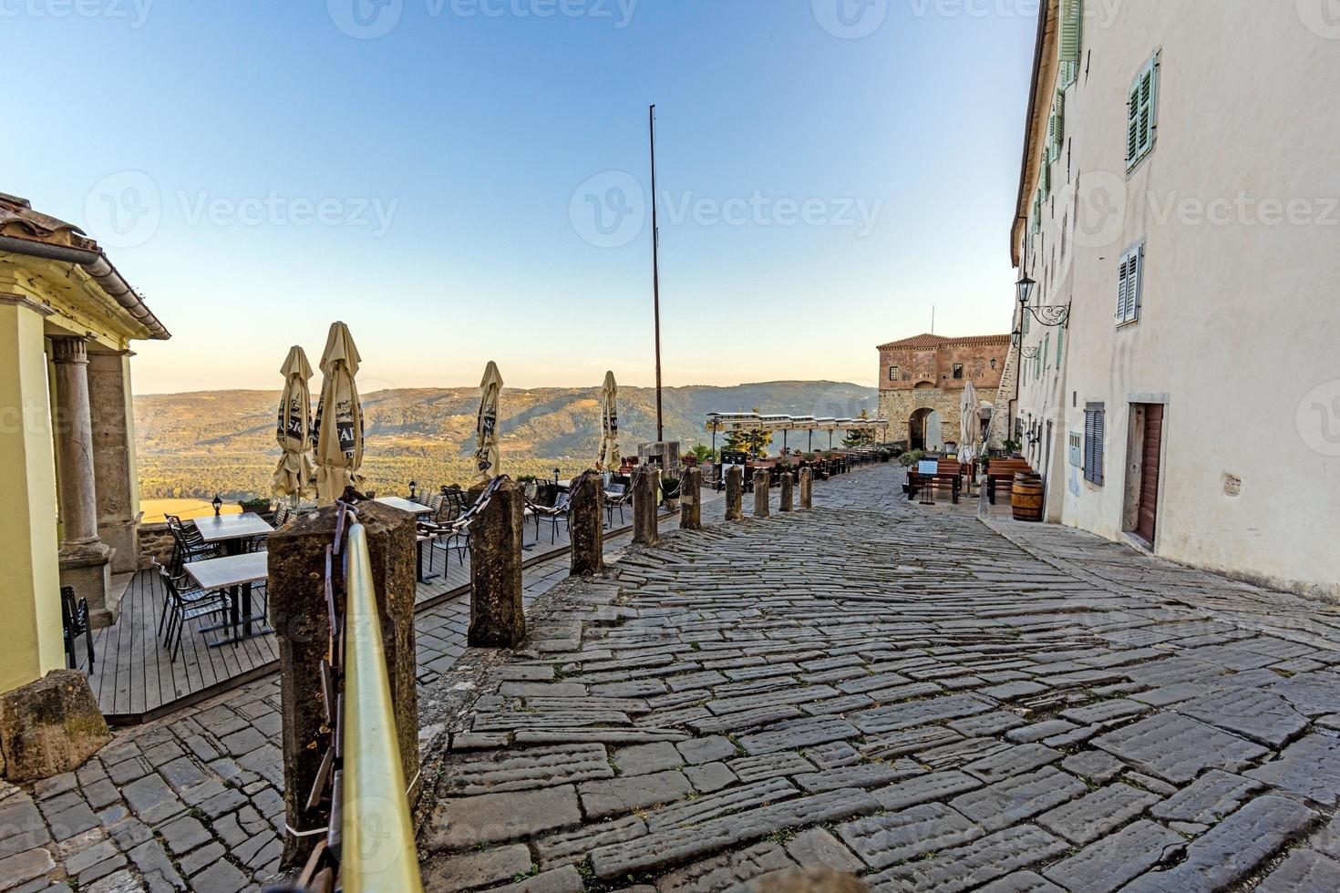 View from the area below the city walls of Motovun over the surrounding countryside during the day photo