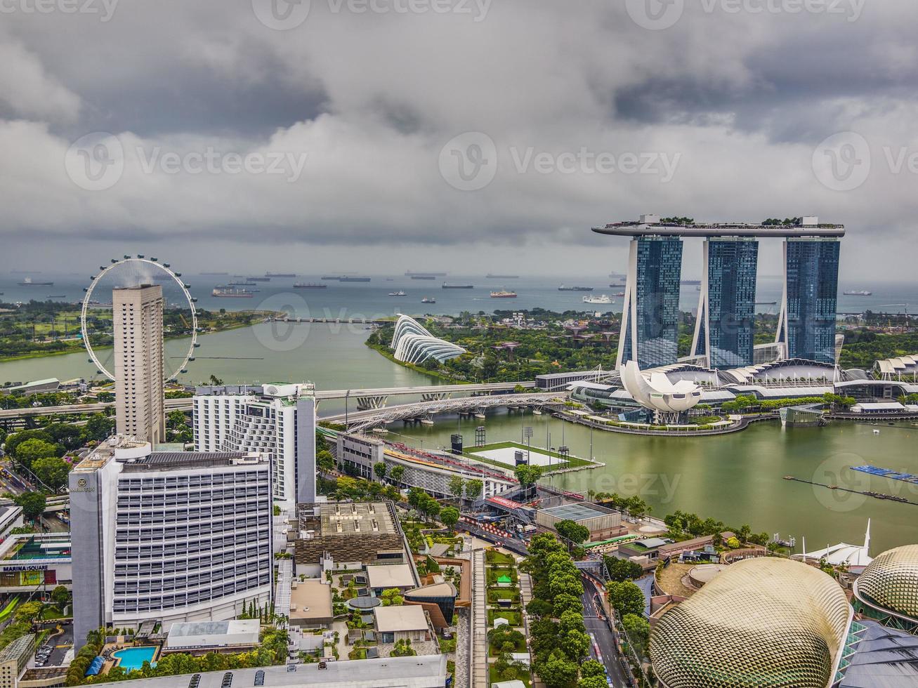 Aerial panoramic picture of Singapore skyline and gardens by the bay during preparation for Formula 1 race during daytime in autumn photo