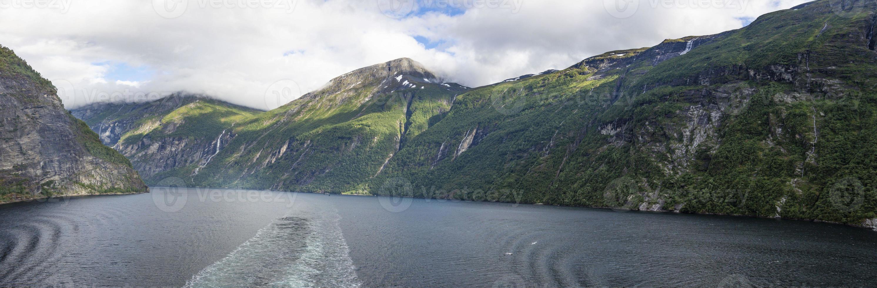 Impression from cruise ship on the way through Geiranger fjord in Norway at sunrise in summer photo