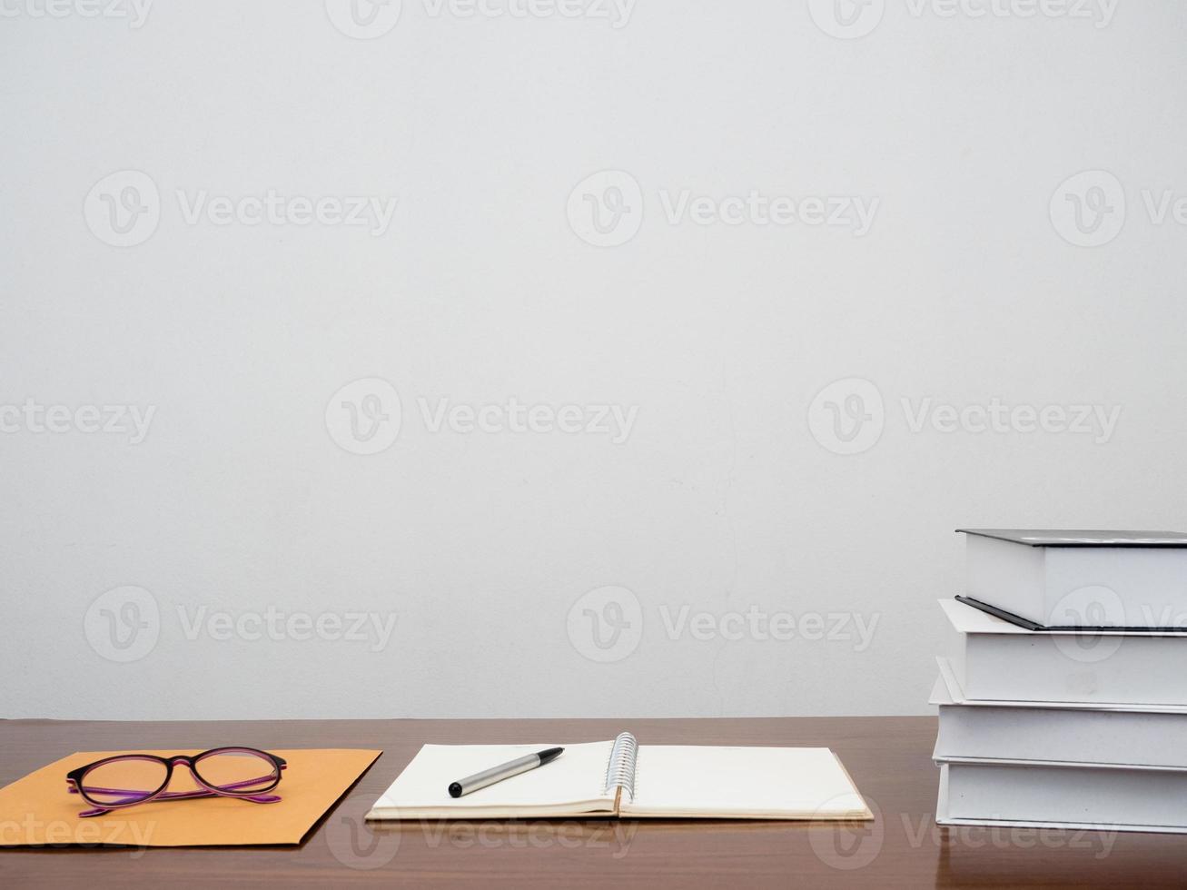 Books with diary on the desk working table of office employee copy space photo