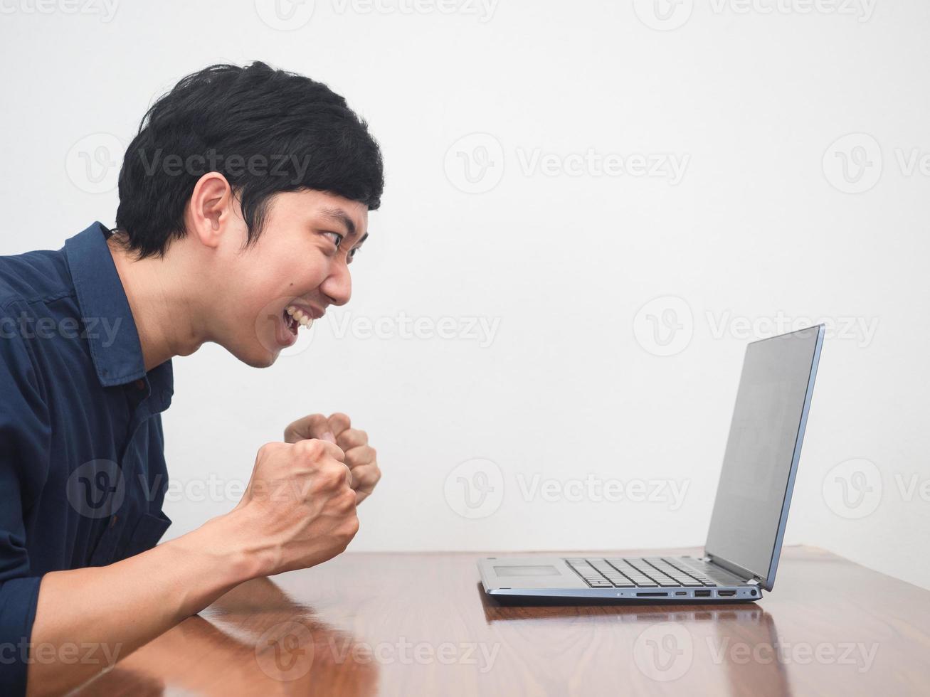 Male employee feels happy about success his working on the table