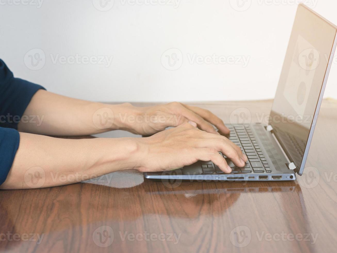 Close up worker man using laptop on the table photo