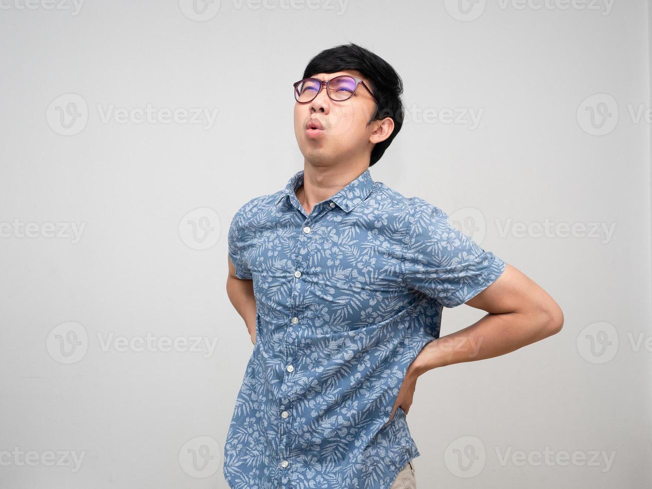 Asian male employee  wear glasses feels pain his back about hard working office syndrome isolated photo