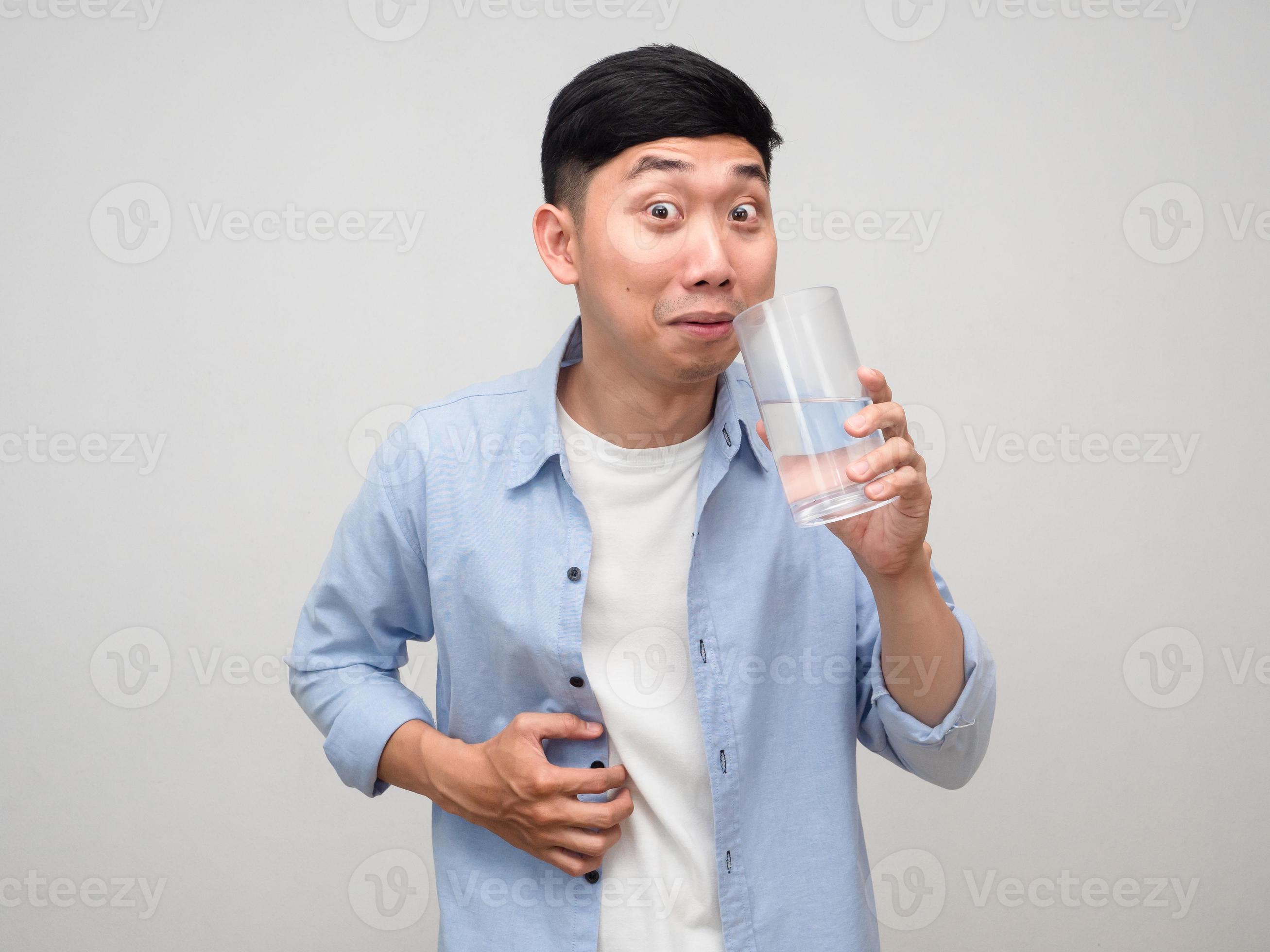 Young man blue shirt hold glass of water gesture choking feels unhappy