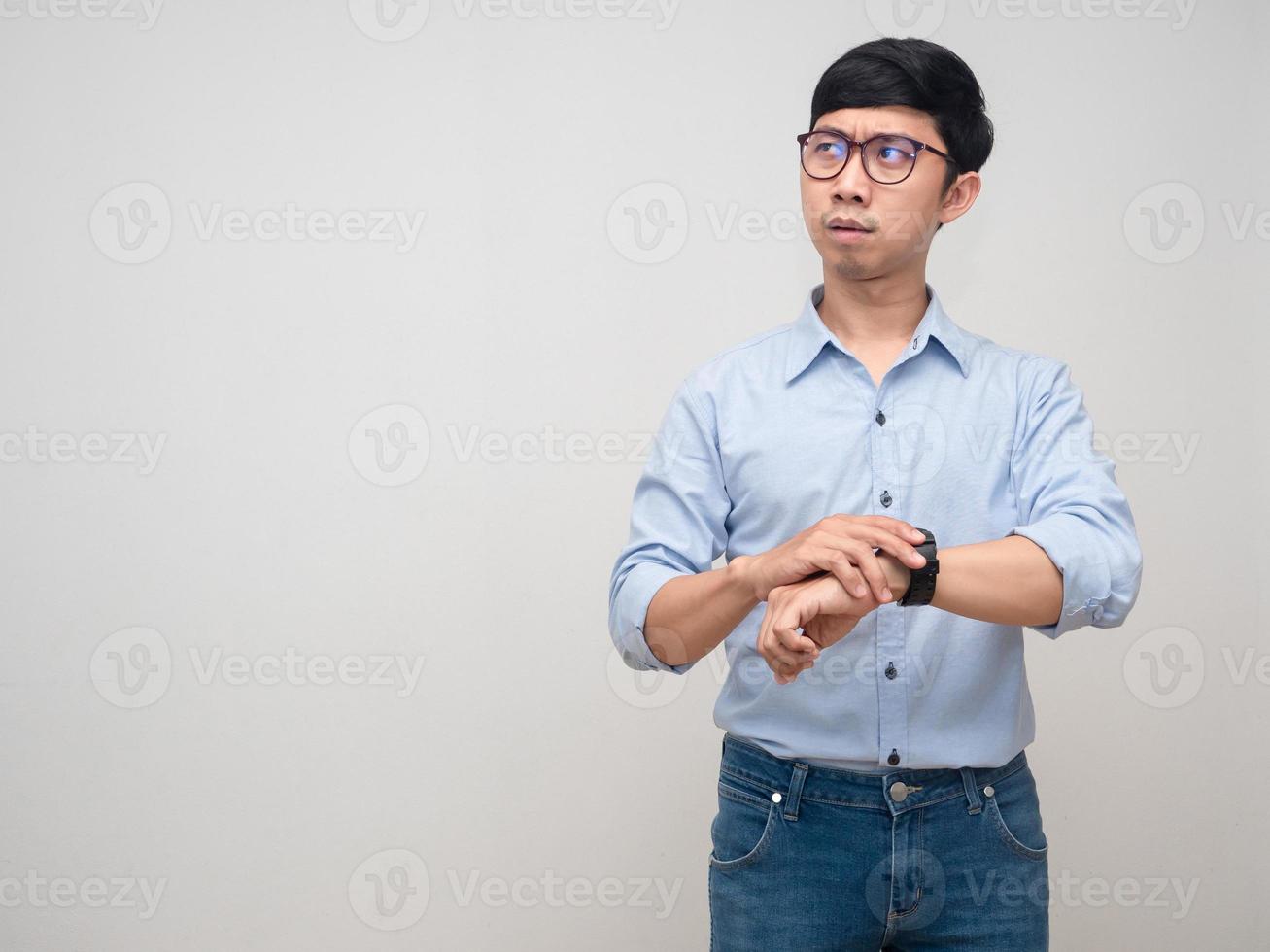 Young businessman busy moment hold his watch looking at copy space photo