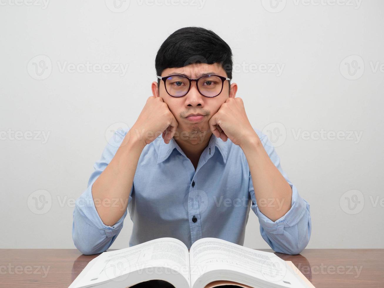 Asian businessman sit at working table feels boring about work photo