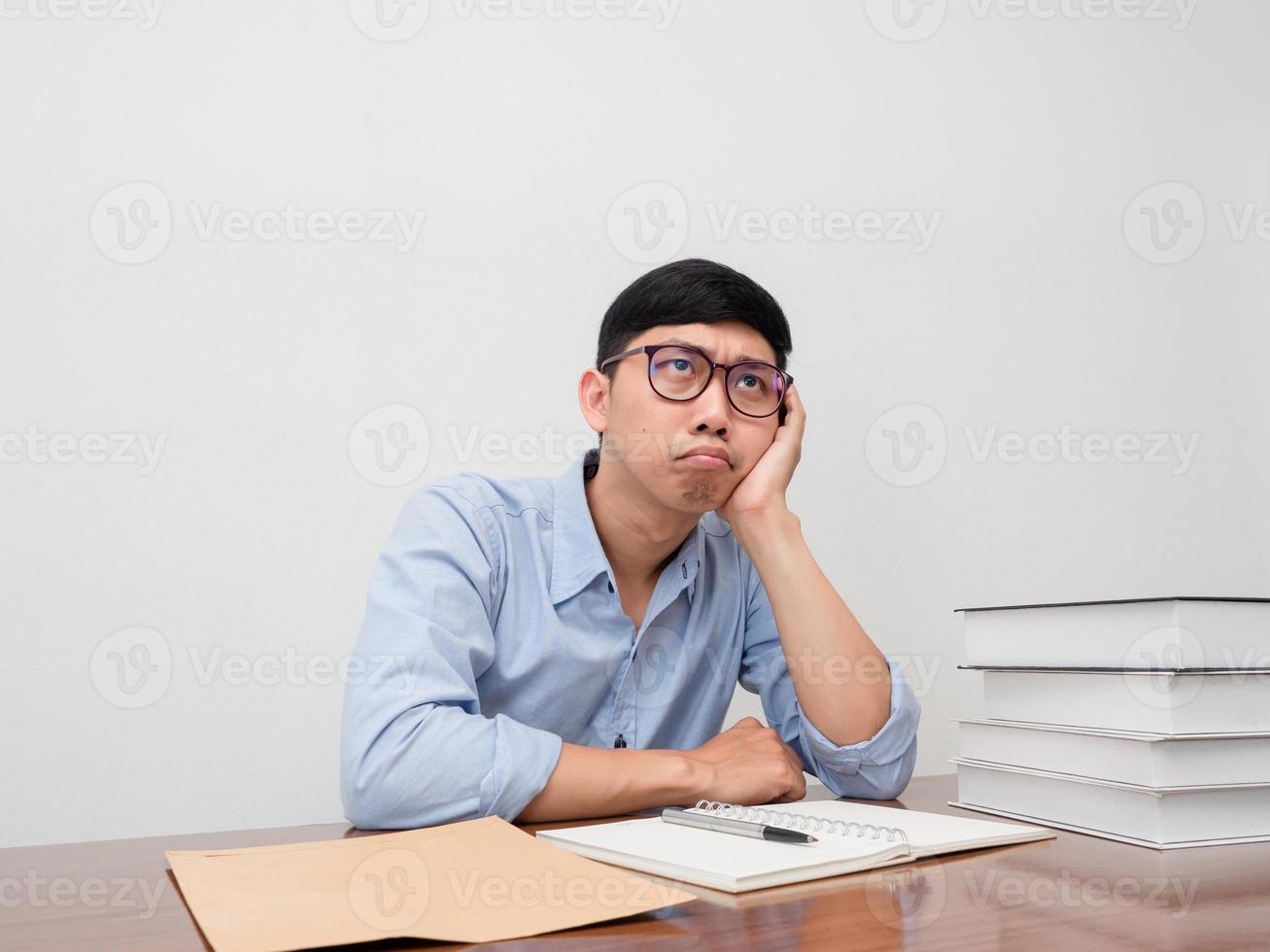 Businessman wear glasses feels bored sit at working table gesture thoughtful about work photo