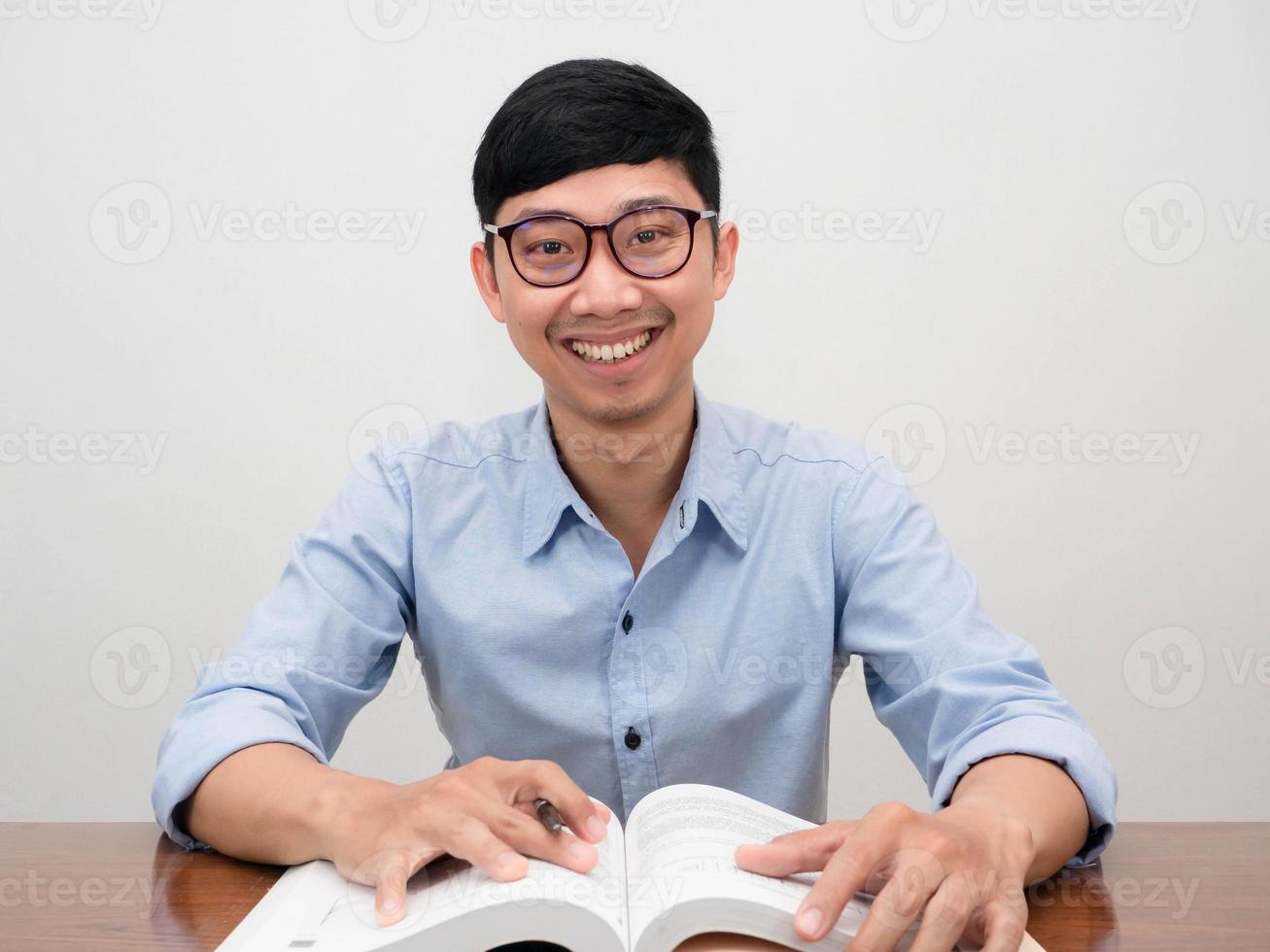 Positive asian businessman glasses confident smile sit at working table photo