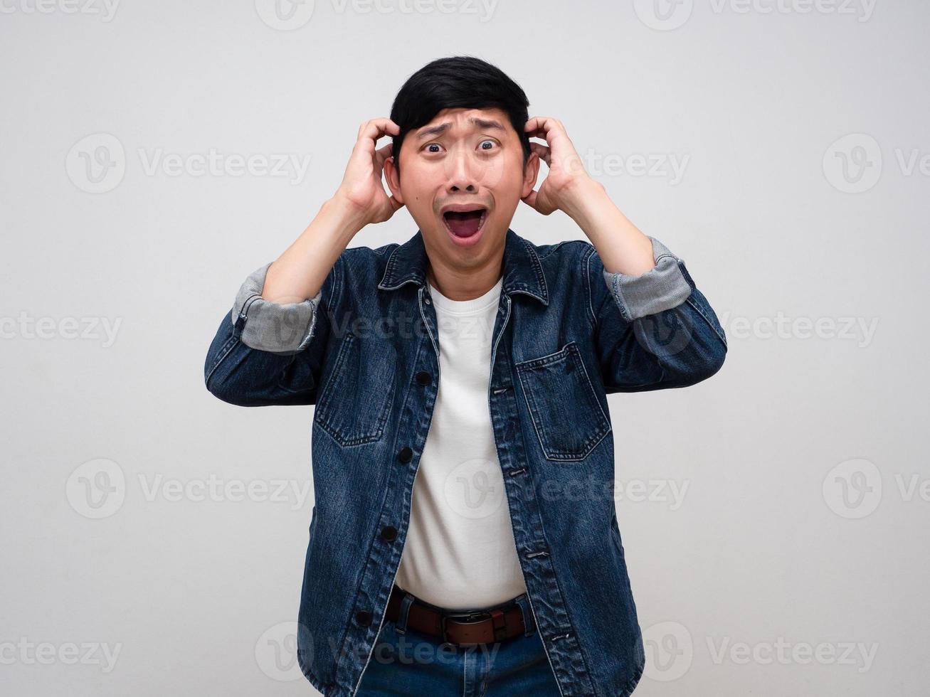 Asian man jeans shirt gesture hold his head feels shocked isolated photo