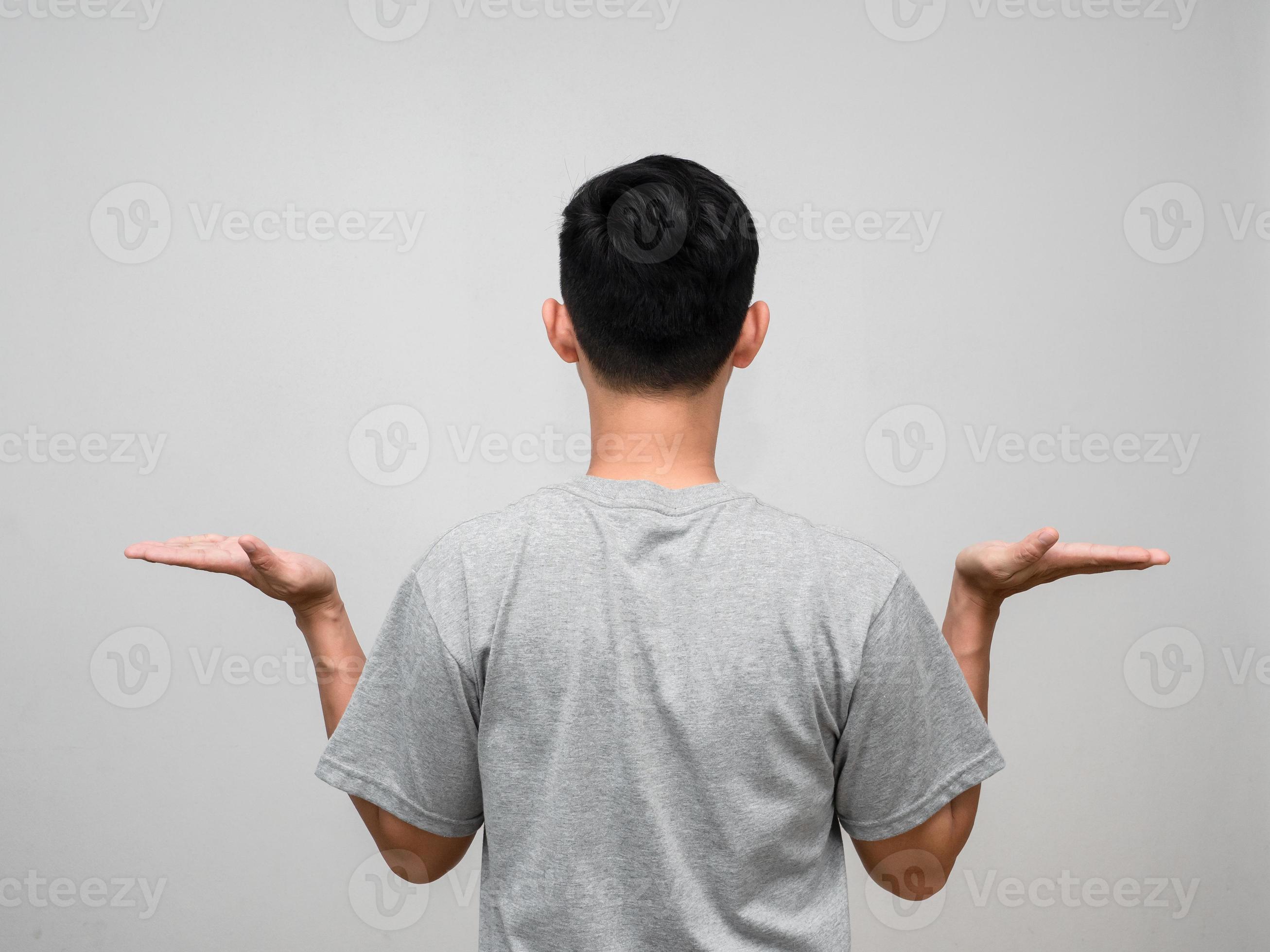 Behind of man grey shirt stand turn back show hands up for holding
