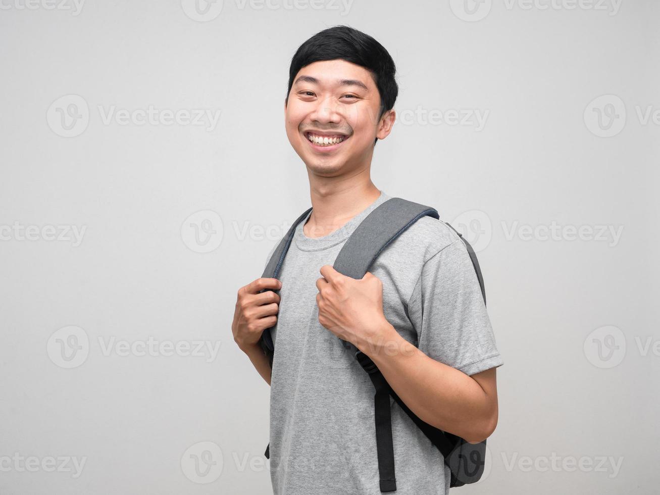 Positive man smile carry backpack isolated photo