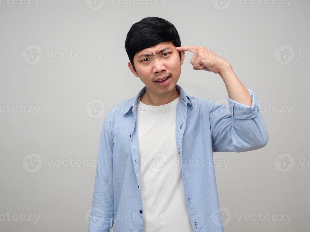 Employee male blue shirt point finger at his head sign to make you thinking isolated photo