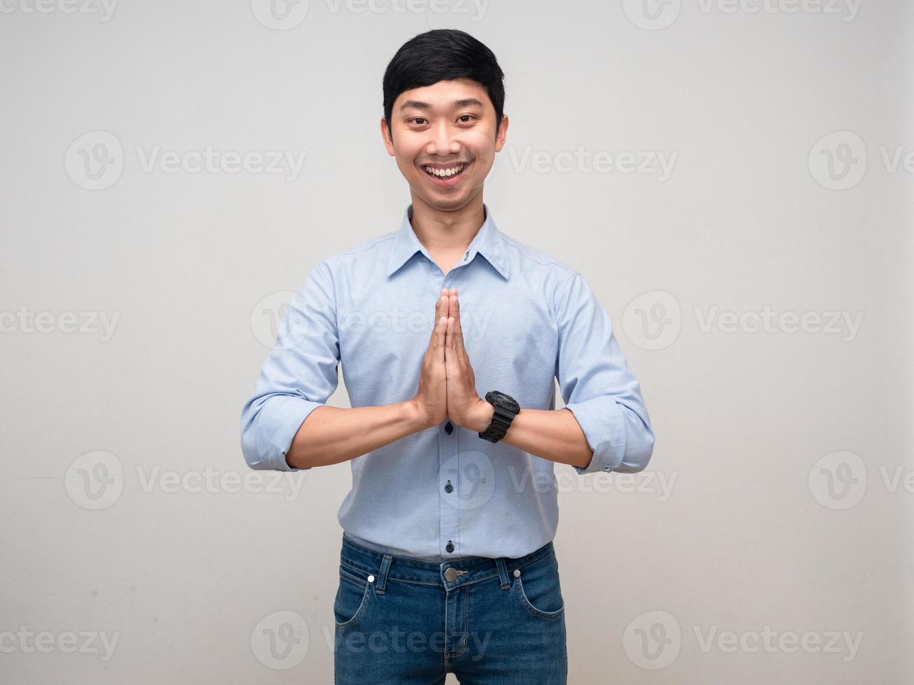 Young thai man gesture respect hand with happy smile isolated photo