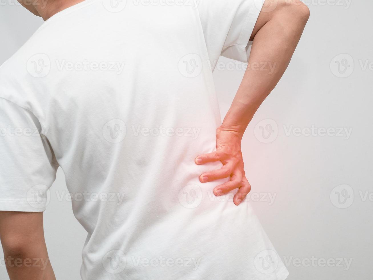 Closeup man hurt his waist from office syndrome concept photo