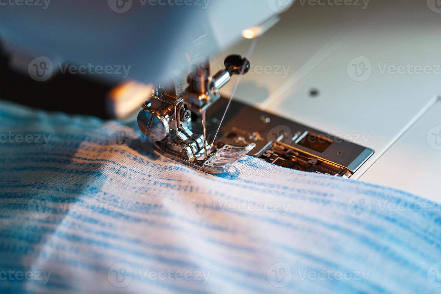 Sewing clothes on a sewing machine close-up. photo