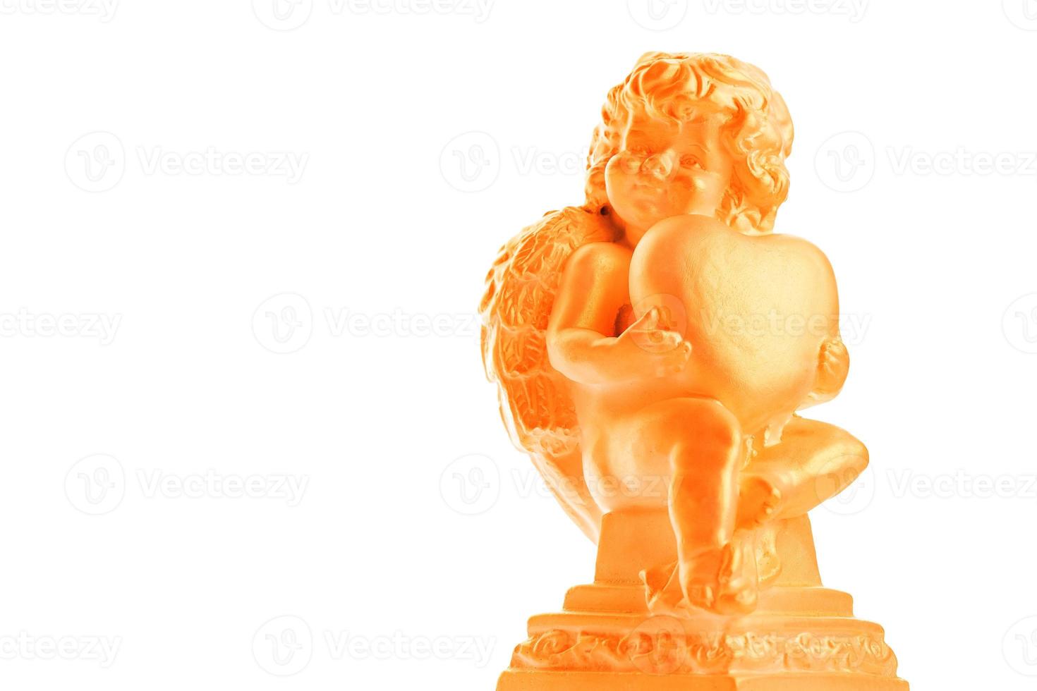 Cherub statue isolated on white background. Angel holds the heart. Love photo