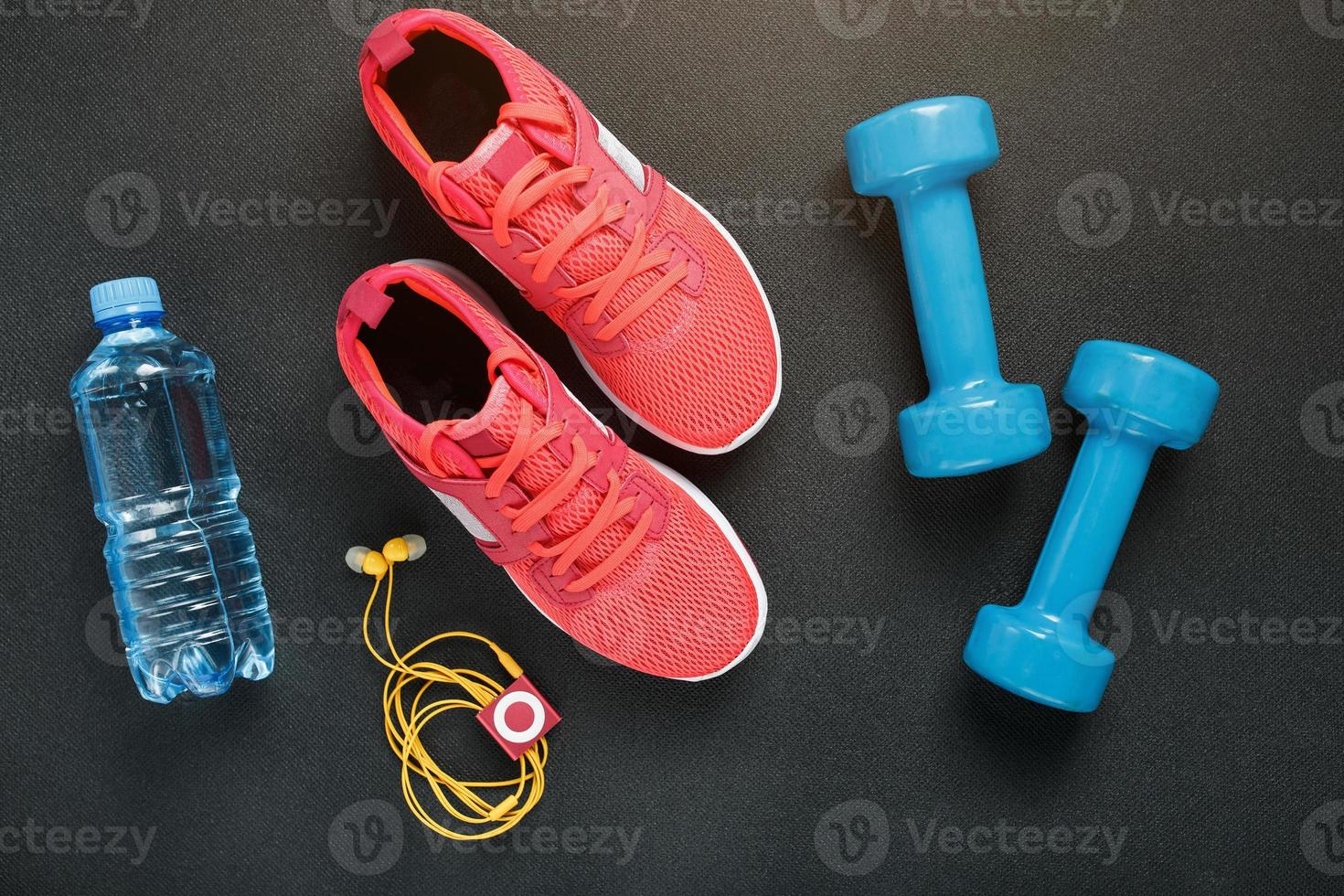 Top view of sportswear, dumbbells and digital devices isolated on grey photo