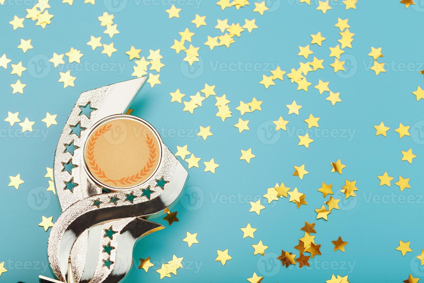 Gold trophy Cup with stars Celebrating success on a blue background. photo