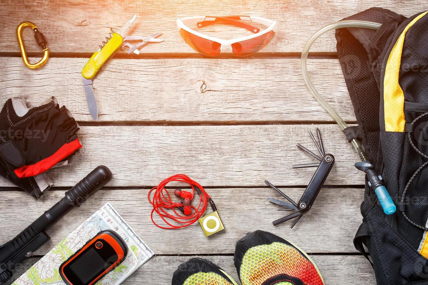 Set of things and tourist equipment for travel and adventure on a gray wooden background. Top view set photo