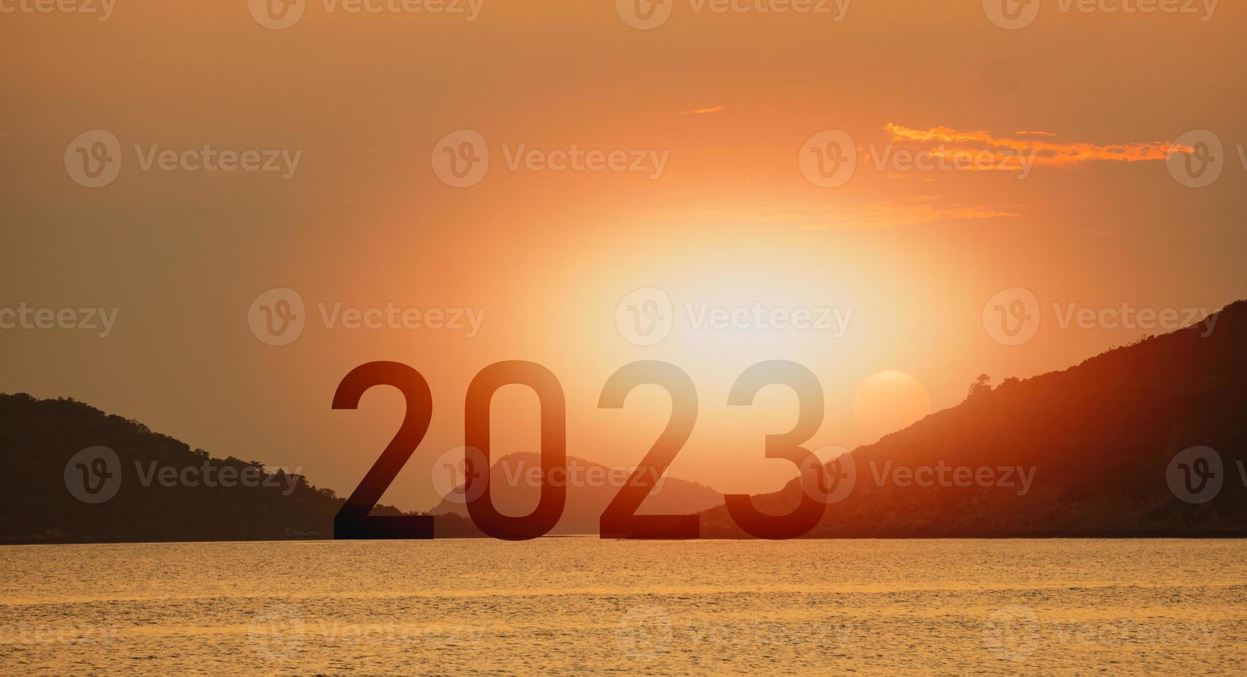 Happy new year 2023 sea mountain sunset success concept, silhouette of island sea mountain view sunlight success with sunset background. Happy New Year 2023 use for web banner and advertisement. photo