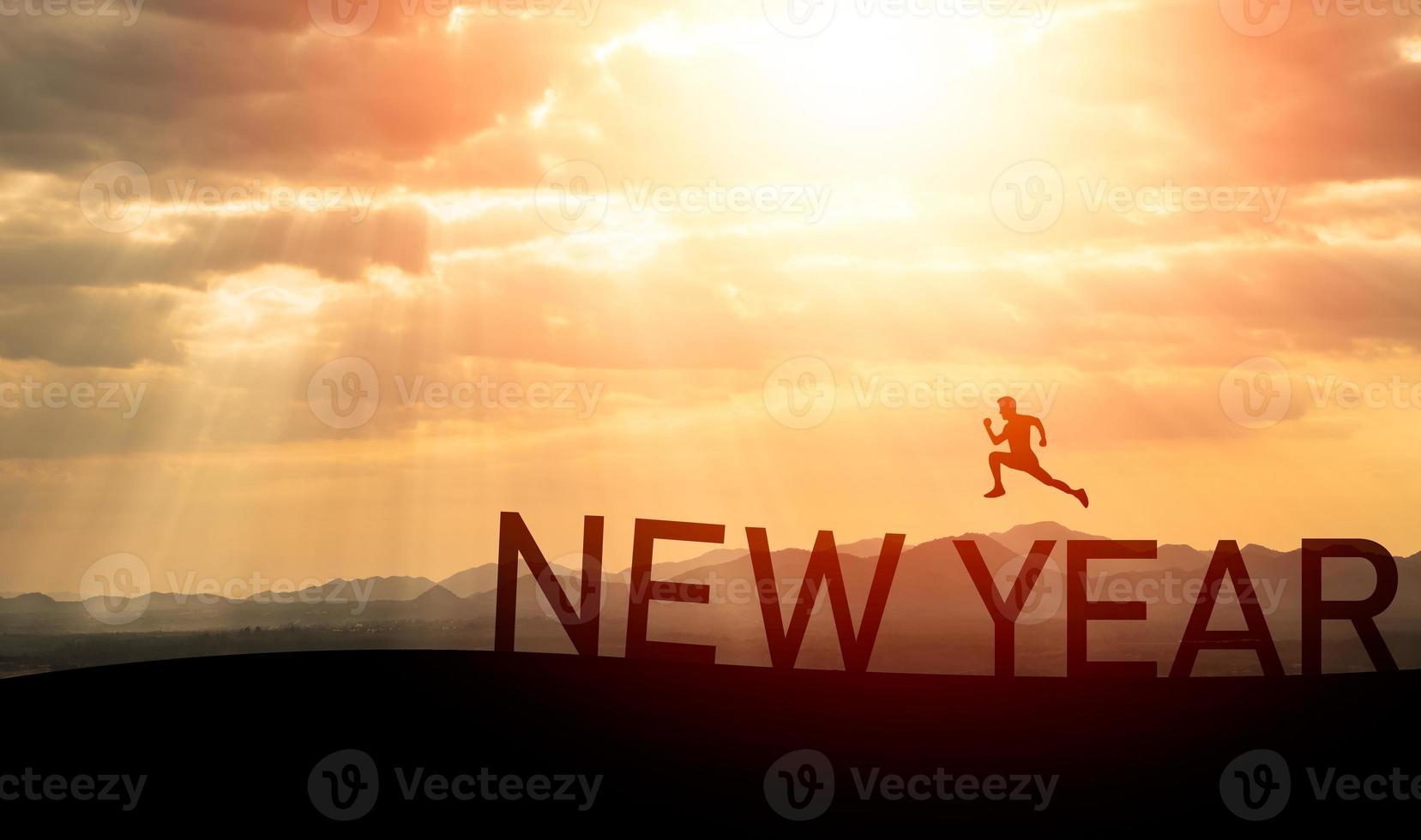 Sport man run jump happy new year 2023 concept, silhouette of man jumping over barrier cliff and success with beautiful sunset background. Happy New Year 2023 use for web banner and advertisement. photo