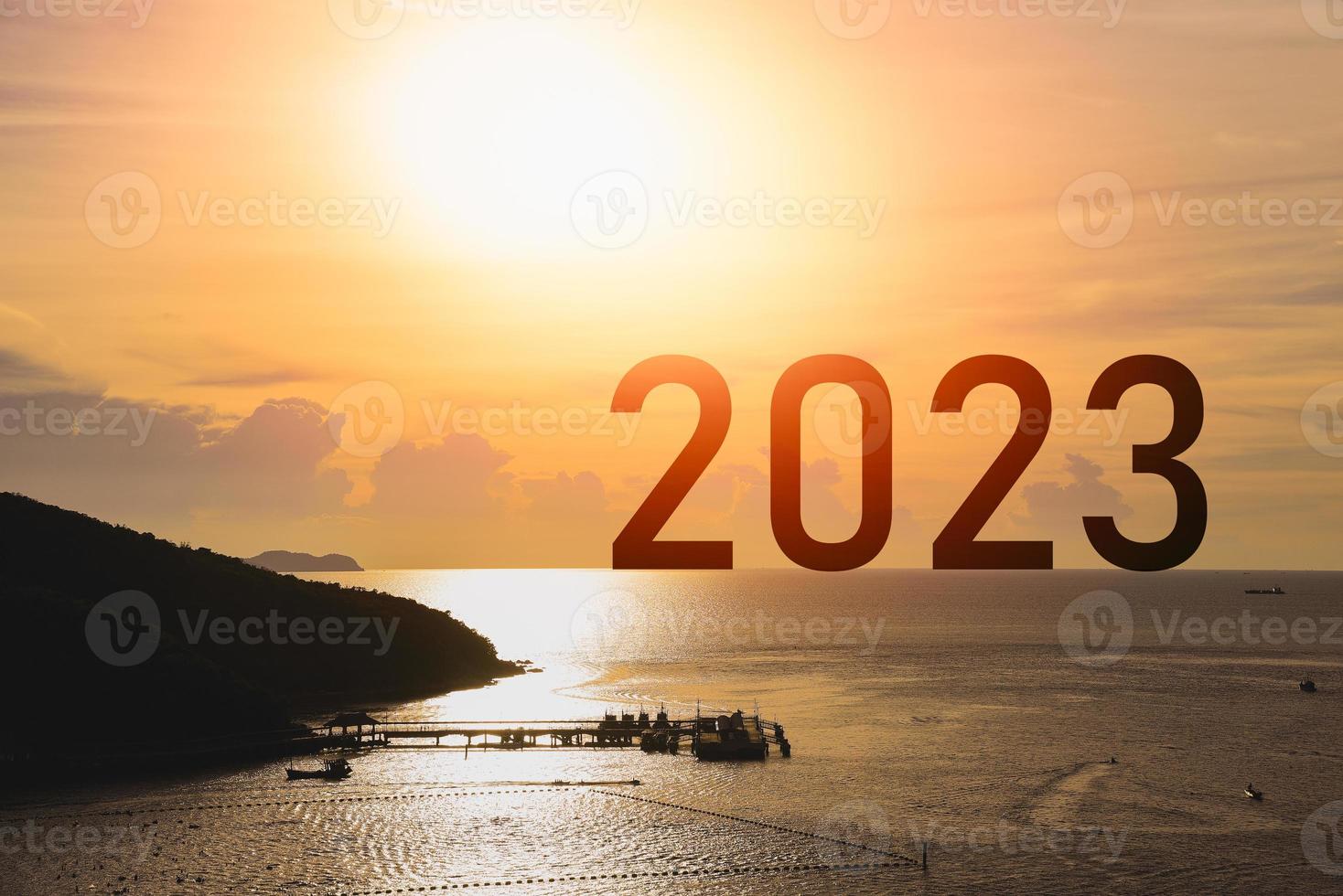 Happy new year 2023 sea mountain sunset success concept, silhouette of island sea mountain view sunlight success with sunset background. Happy New Year 2023 use for web banner and advertisement. photo